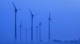 Wind turbines with warning lights glowing in the dark