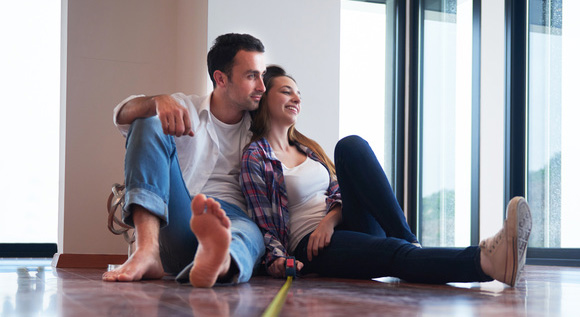Couple sitting on the floor of their new house.