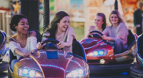 Four young women in bumper cars.