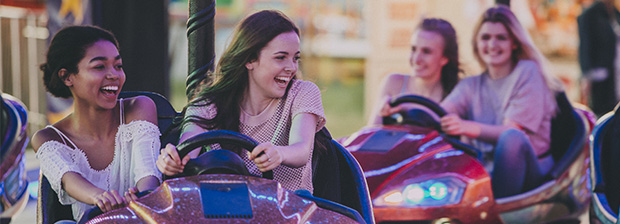 Four young women in bumper cars.