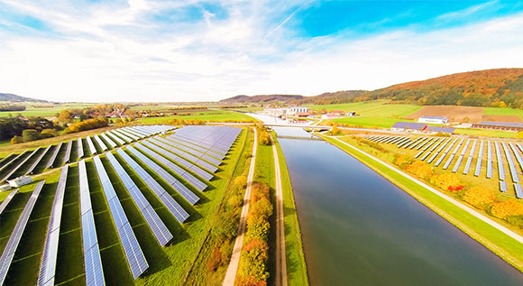 Cultivaed landscape with canal and solar farms.